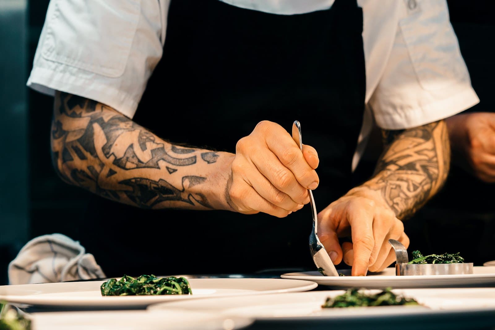 A chef plating a dish by hand