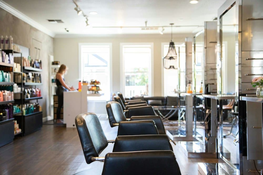 Bright salon floor with styling chairs and mirrors