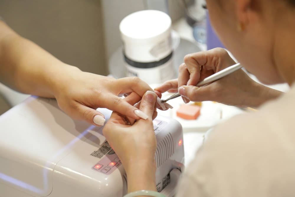 Nail artist working on a gel manicure