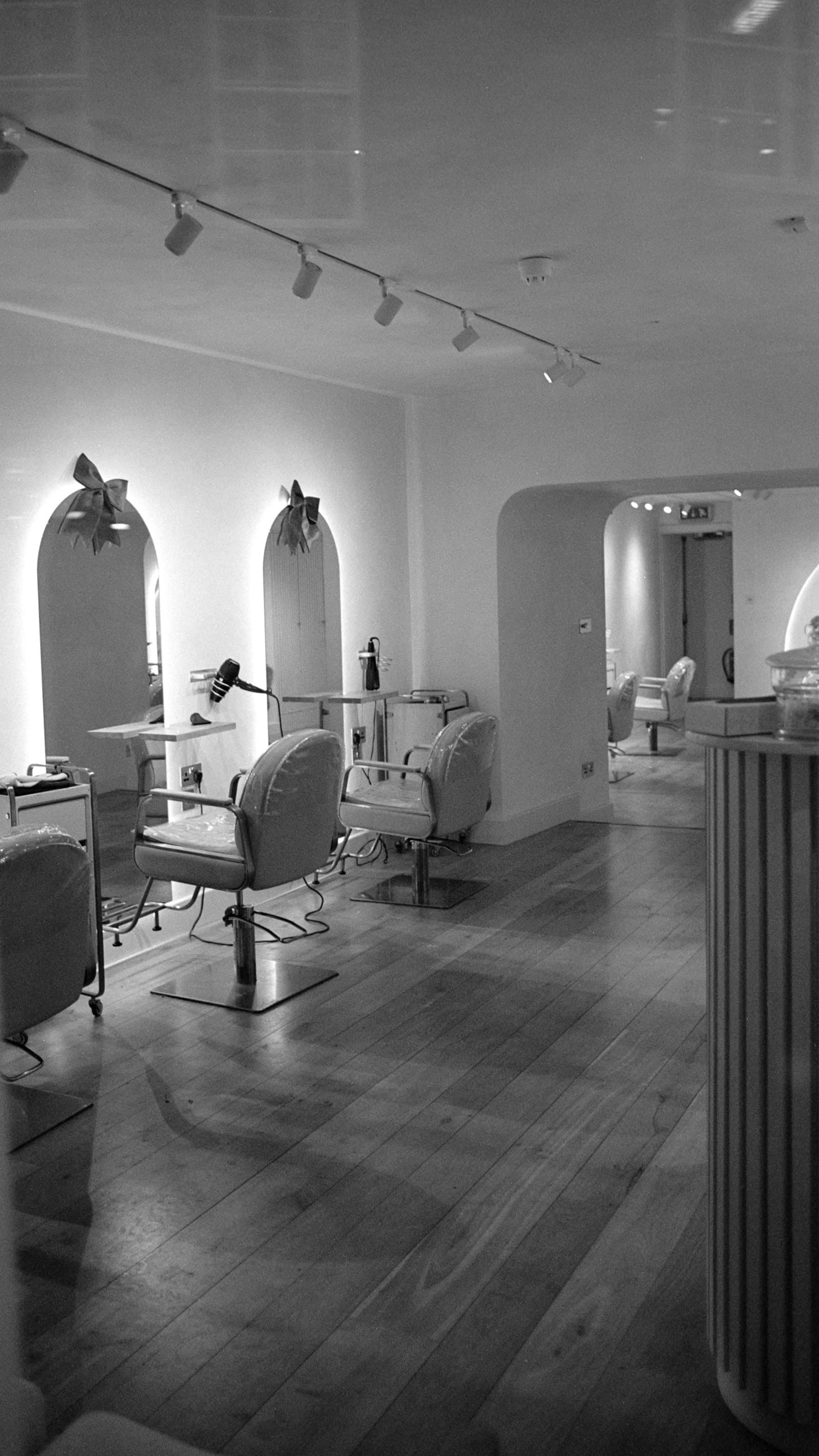 Arched mirrors and styling chairs in a bright salon