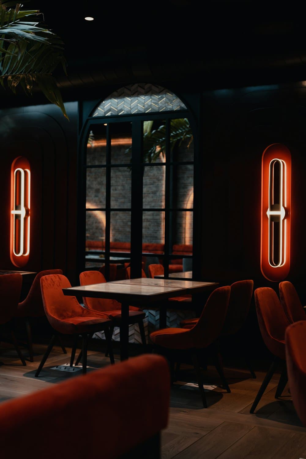 Red booth seating and glowing wall lights