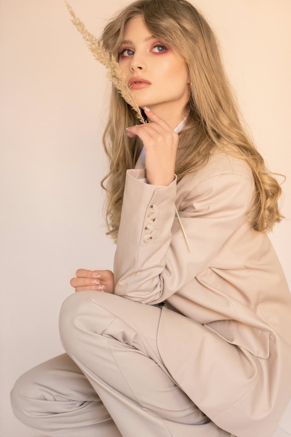 Model seated in a cream linen set