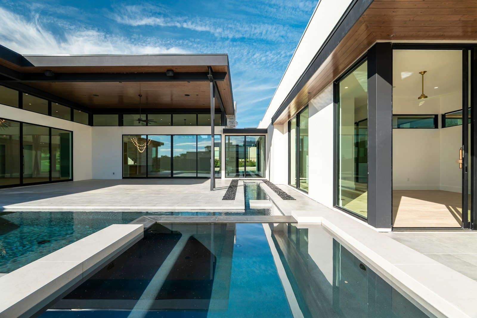 Modern villa with a long pool at dusk