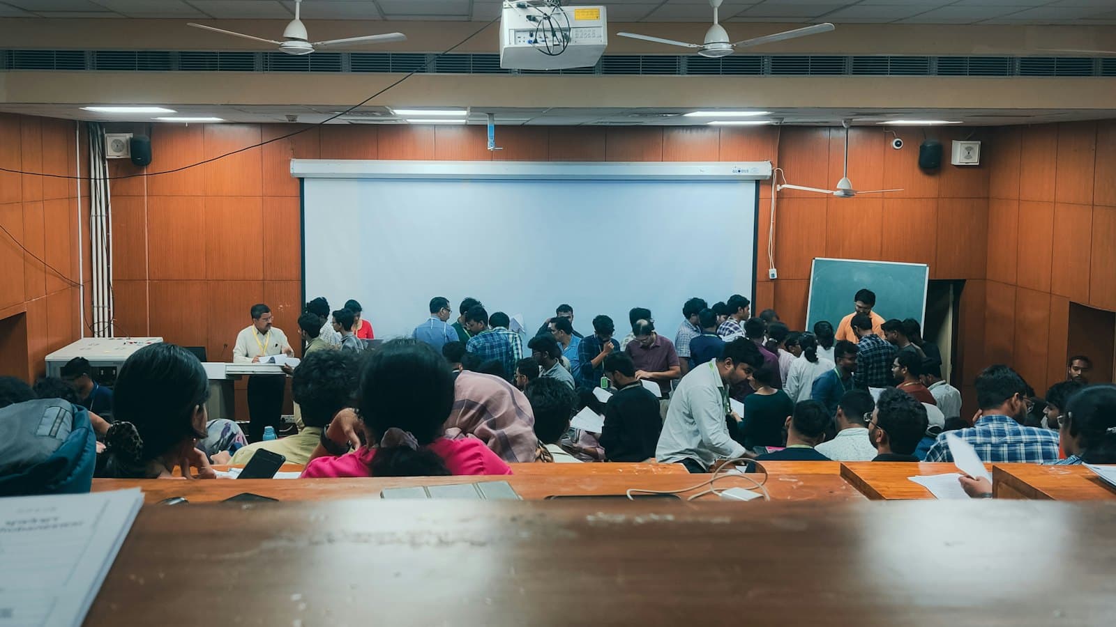 Students in a coaching lecture hall facing the board