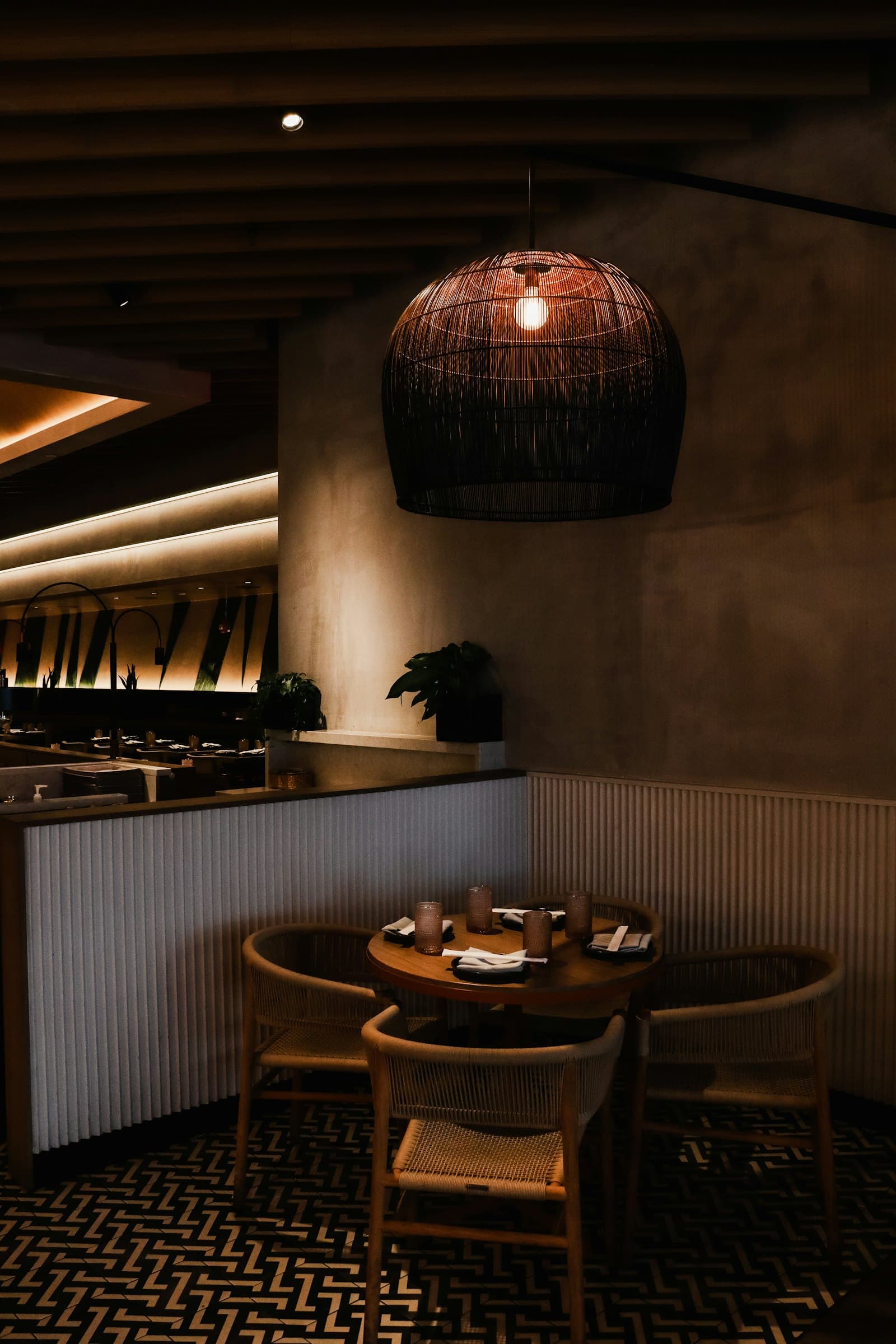 Round tables under a woven pendant lamp