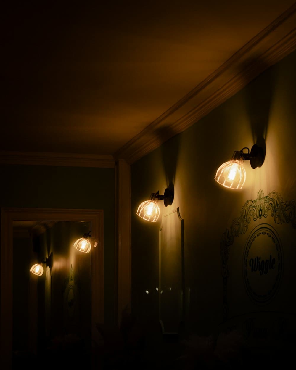 Warm wall lamps in a dark dining room